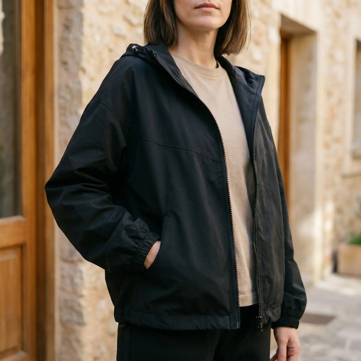 Women's full-zip hooded windbreaker jacket for casual everyday wear in unpredictable spring & fall weather.