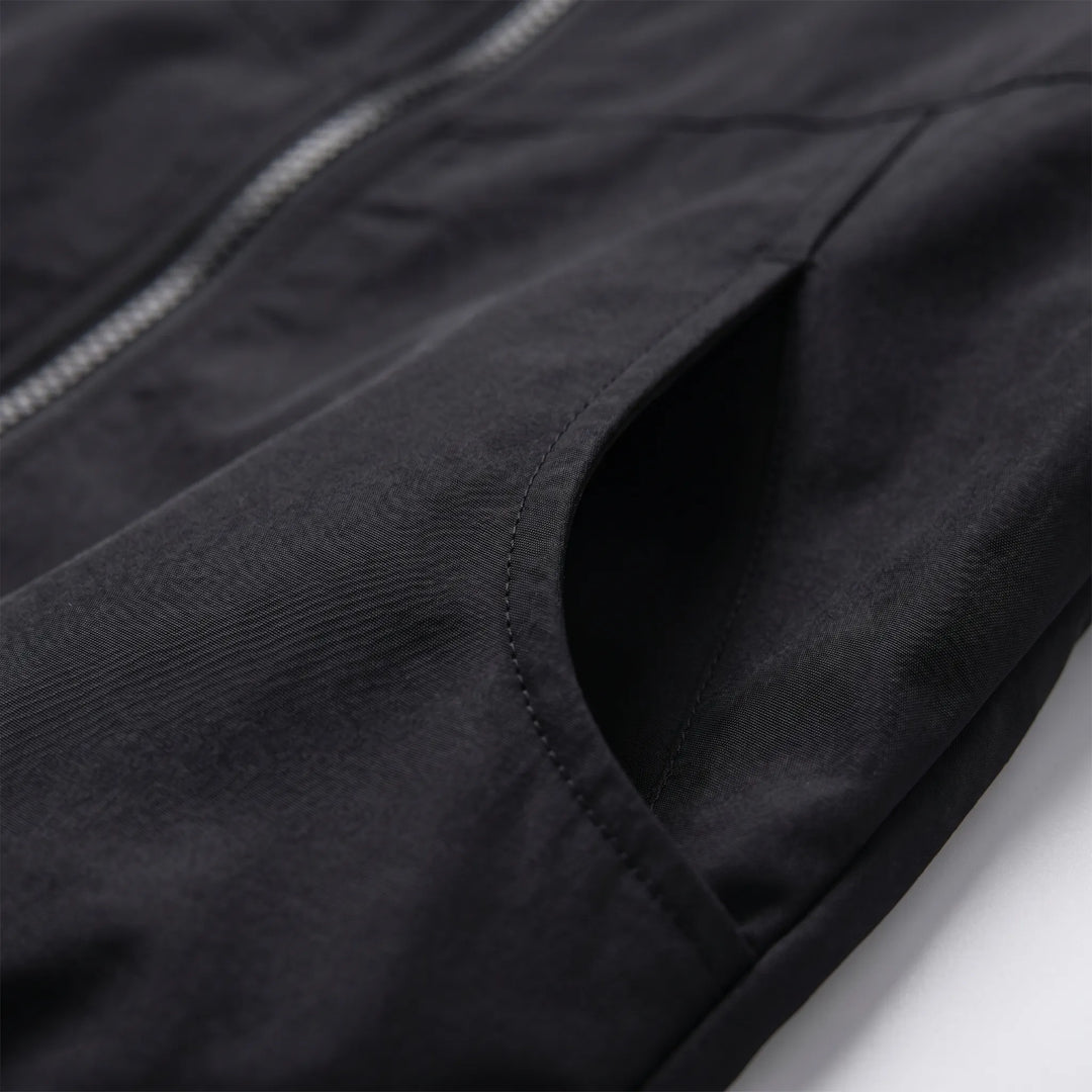 Versatile women's hooded windbreaker jacket offering lightweight protection for unpredictable weather. Full zip design.