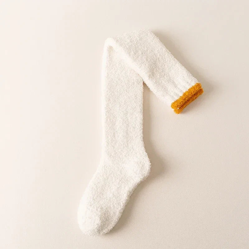 Plush fuzzy knee high socks for women, offering cozy warmth & comfort. Ideal solid color loungewear for winter.
