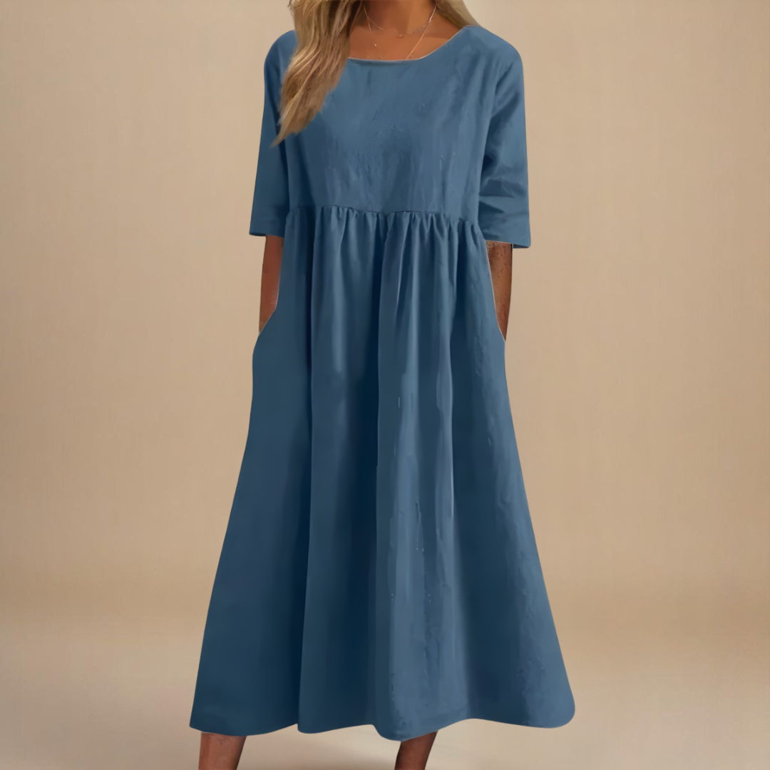 Front view: Women's casual midi dress, featuring gathered empire waist, half sleeves, and a flattering flowy fit.