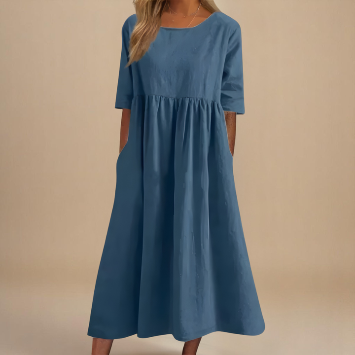 Front view: Women's casual midi dress, featuring gathered empire waist, half sleeves, and a flattering flowy fit.