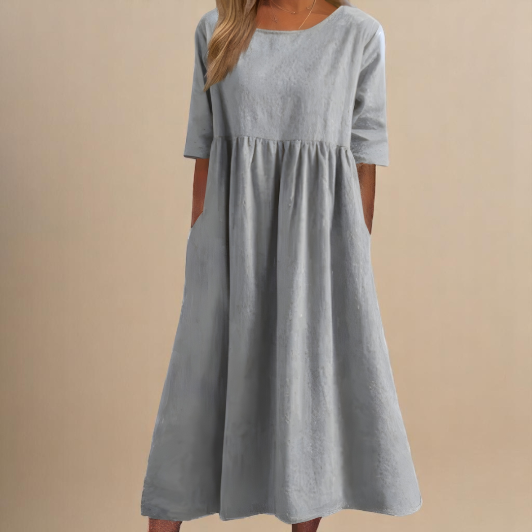 Detailed view of the gathered waist & half-sleeves on a women's elegant midi dress. Perfect for everyday style.