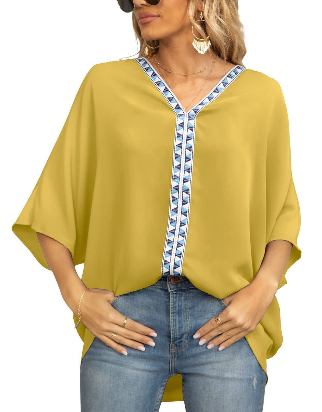 Relaxed fit women's tunic blouse with intricate geometric trim and a flattering V-neck design.