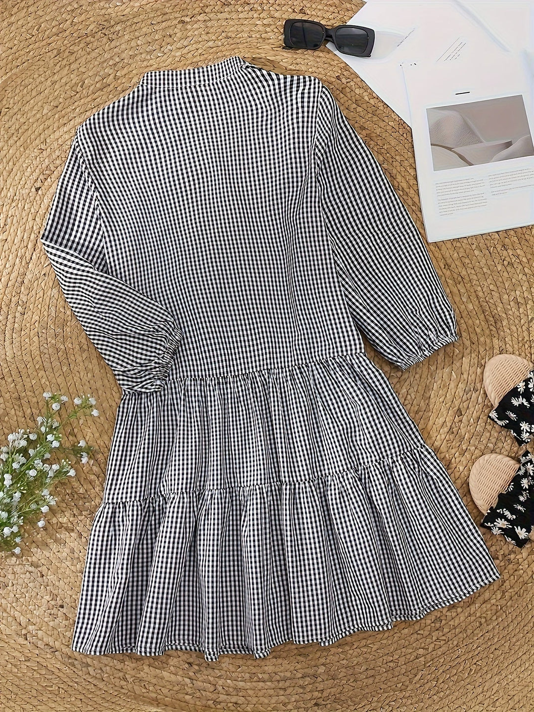 Effortless women's tiered mini dress in gingham check. Features puff sleeves and a flowing summer silhouette.