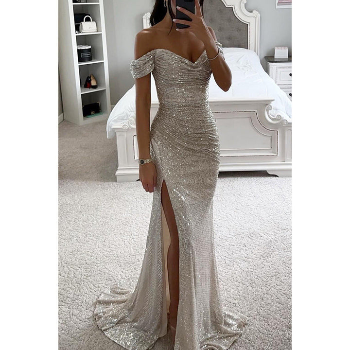 Detailed view of the high slit on a women's glamorous sequin off-shoulder gown. Elegant formal wear design.