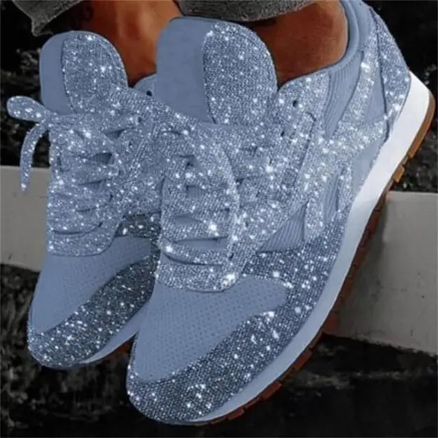Close-up of women's sparkling glitter lace-up sneakers, highlighting the shimmering texture and stylish design.