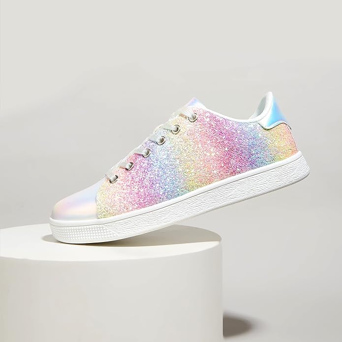 Pair of women's fashion sneakers with glitter finish & lace-up closure. Stylish ladies casual footwear.