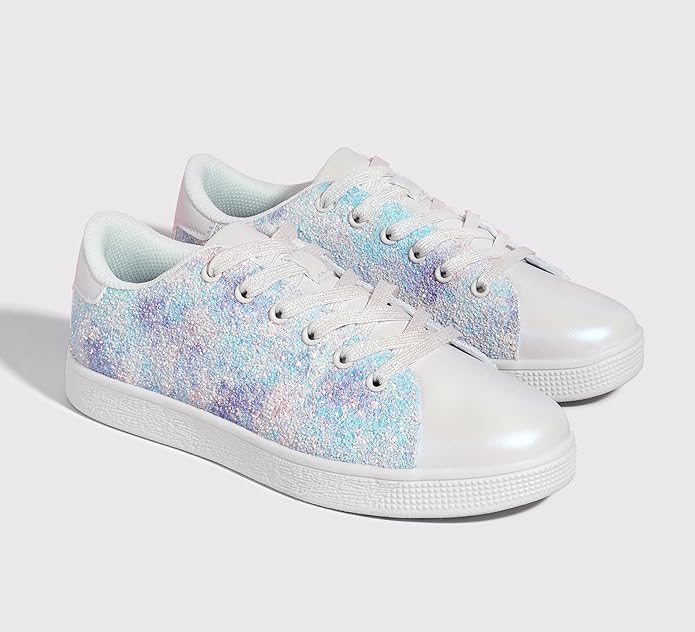 Woman wearing comfortable glitter lace-up fashion sneakers for a trendy casual look. Sparkle shoes.
