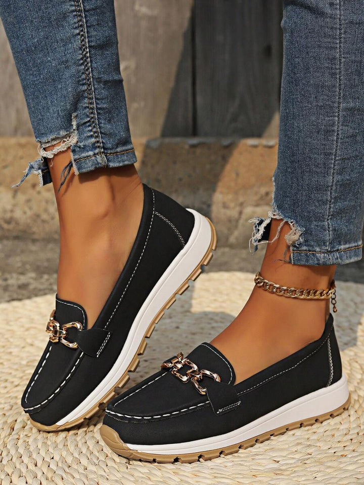 Back view of women's comfort flatform loafers, highlighting the sturdy sole and elegant gold chain detail.