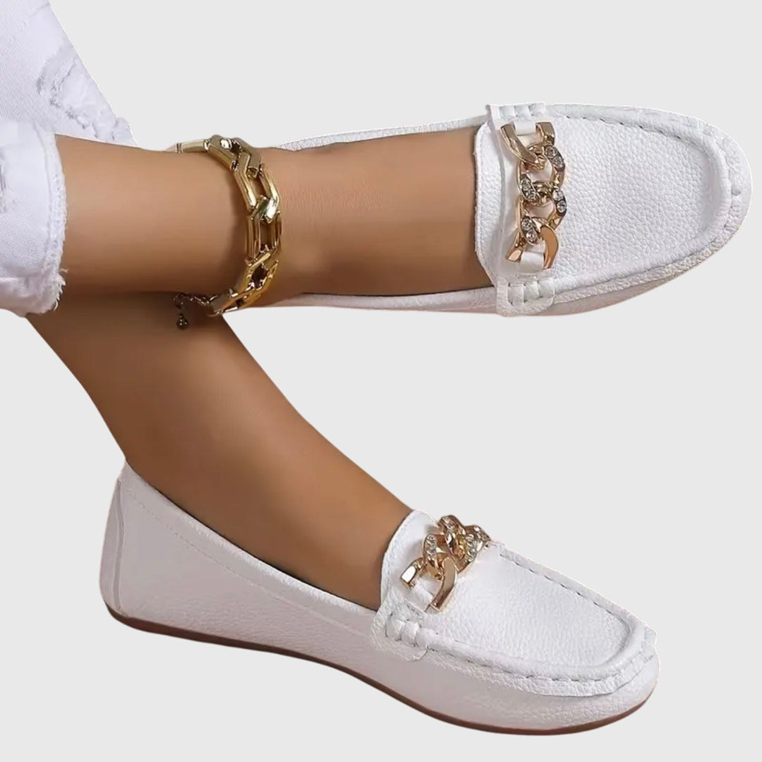 Women's gold-chain wedge loafers with crystal detail, elegant and stylish slip-on shoes.