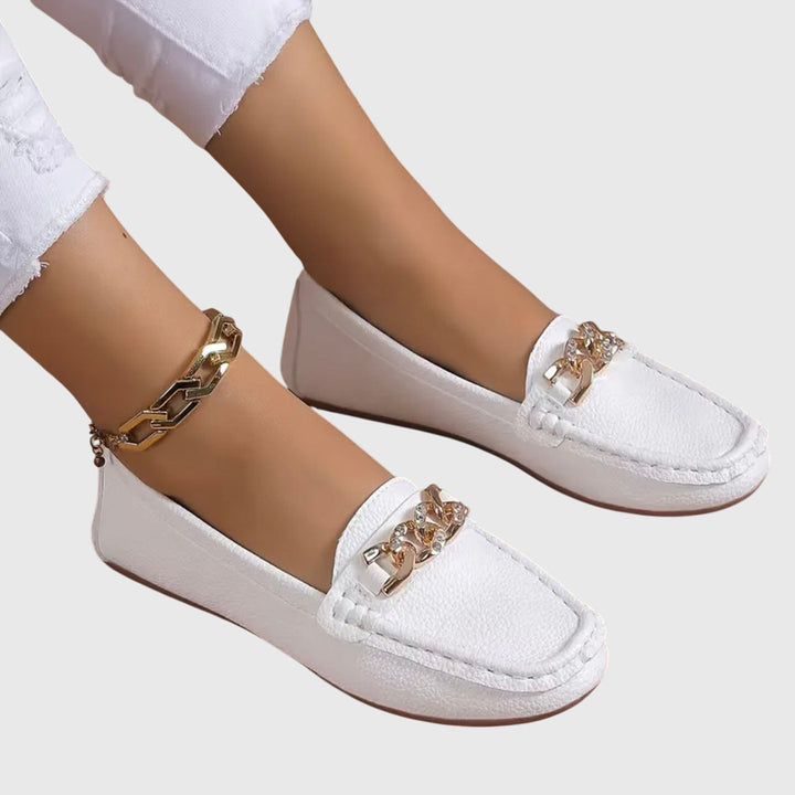 Sophisticated women's gold-chain wedge loafers with crystal detail, blending style and comfort.