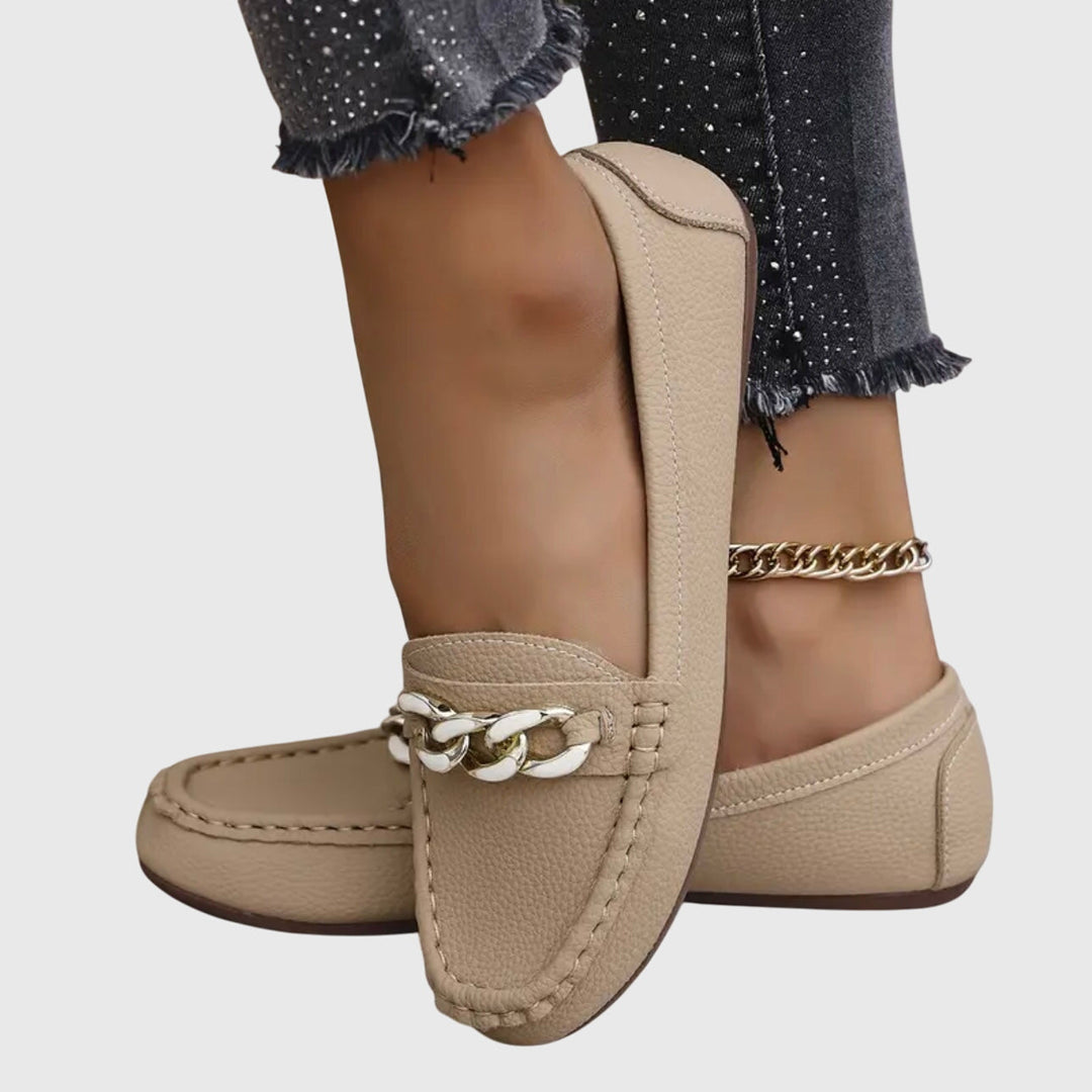 Stylish women's slip-on wedge loafers with a round toe, gold chain, and elegant crystal detail.