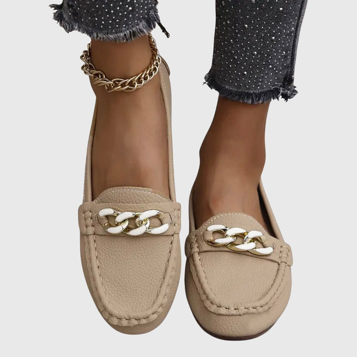 Elegant women's gold-chain wedge loafers with crystal detail, offering everyday glamour & comfort.