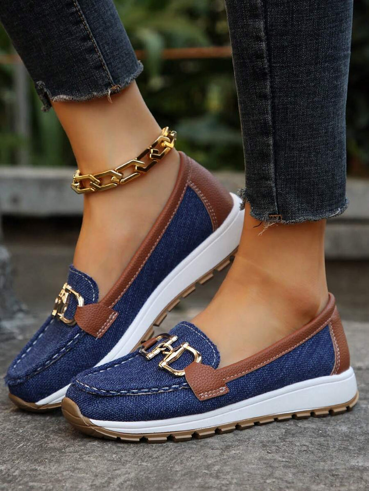 Elegant women's horsebit loafers with gold trim. Classic slip-on style, perfect for sophisticated comfort.