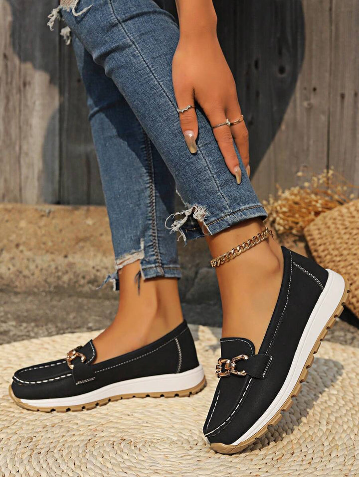 Professional women's horsebit loafers with gold trim. Stylish slip-on shoes for comfortable office wear.
