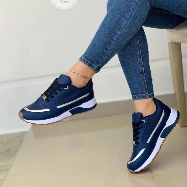 Comfortable women's platform sneakers with elegant gold trim & lace-up design for versatile fashion.