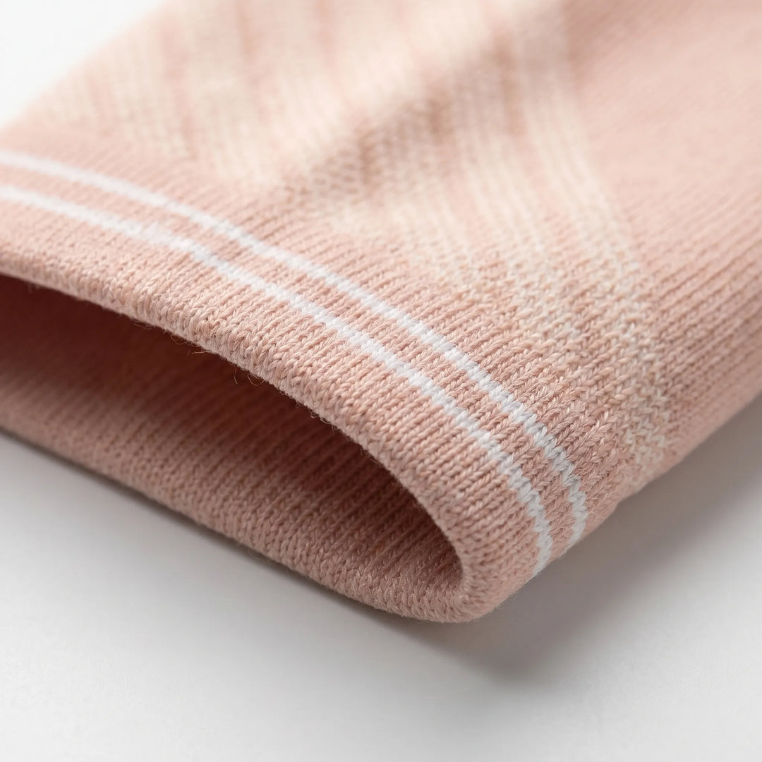 Women's graduated compression knee-high travel socks, reducing fatigue & improving circulation on long journeys & flights.