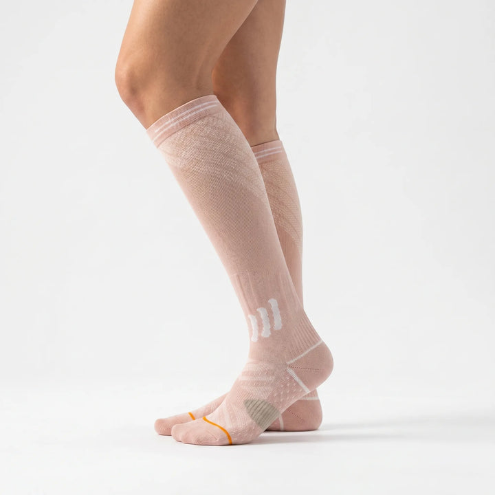 Athletic women's graduated compression knee-high socks, offering muscle support, faster recovery, and enhanced performance.