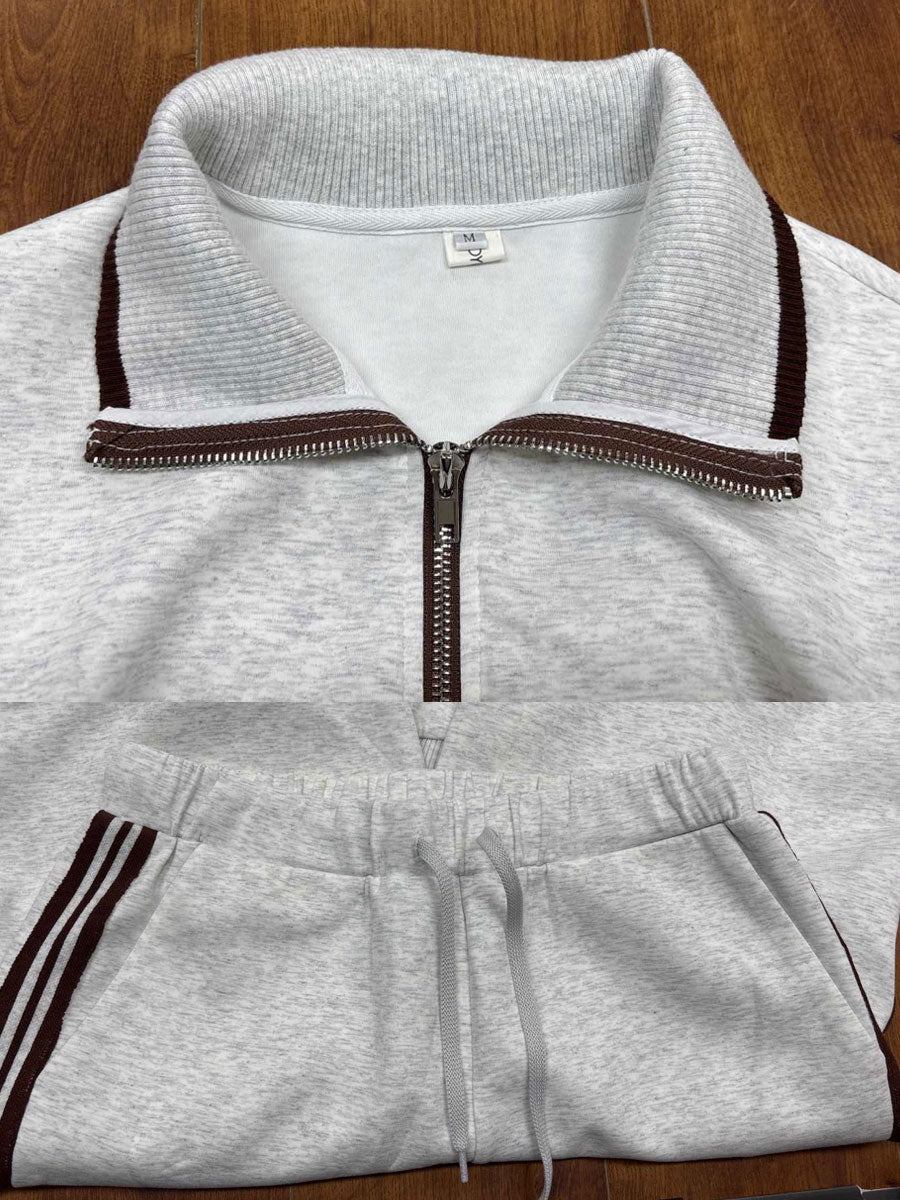Women's leisurewear outfit: comfy half-zip sweatshirt paired with wide-leg pants for a relaxed look.