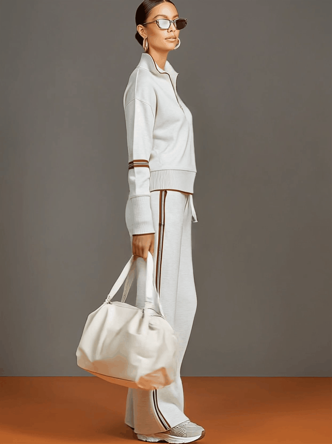 Stylish women's co-ord set featuring a half-zip sweatshirt and flowing wide-leg pants for relaxed wear.