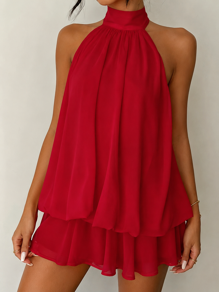 Trapeze fit women's halter mini dress, flowy design, open back, and a stylish ruffle hem for events.