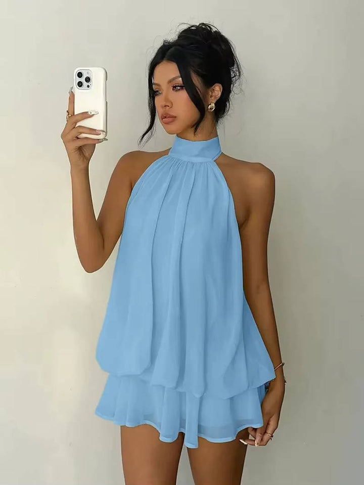 Elegant women's halter mini party dress, flowy trapeze design with an open back & ruffle hem.