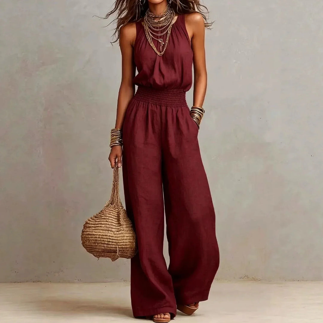 Stylish women's wide leg jumpsuit featuring a halter neck and smocked waist, great for day or evening wear.