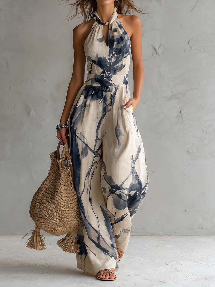 Women's halter neck wide leg jumpsuit with practical pockets, ideal for summer elegance and style.