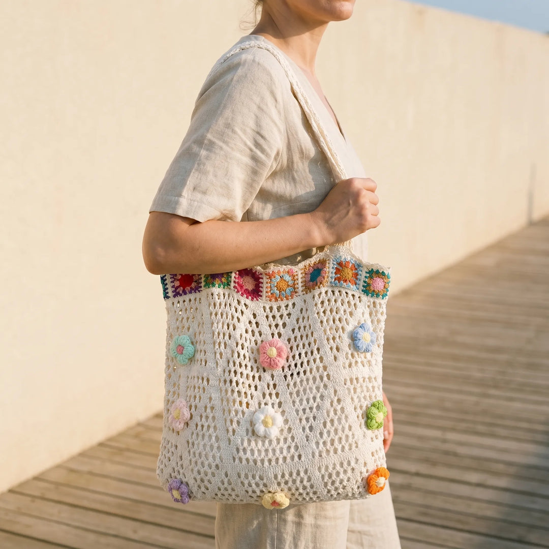 Women's hand-crocheted flower tote bag, perfect for summer beach days or a casual bohemian look.