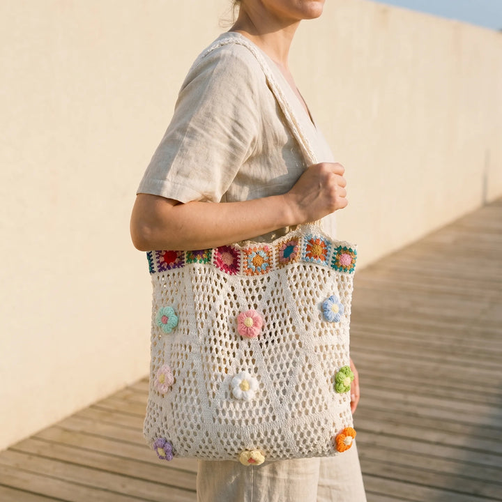 Women's hand-crocheted flower tote bag, perfect for summer beach days or a casual bohemian look.