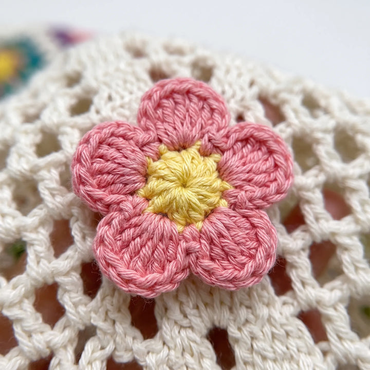 Hand-knitted women's crochet flower tote bag with a unique design, great as a summer shoulder or beach bag.