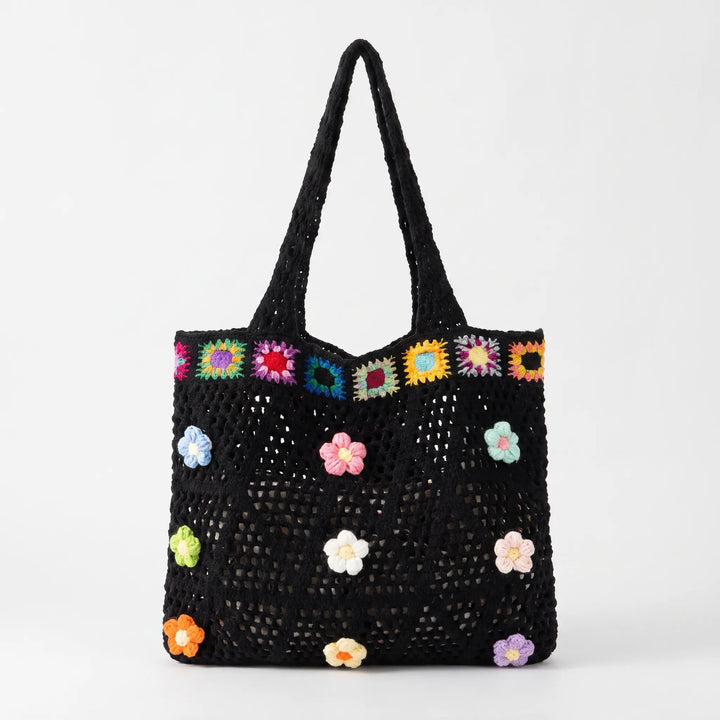 Chic women's crochet flower tote bag, perfect as a spacious summer beach bag or a fashionable everyday accessory.
