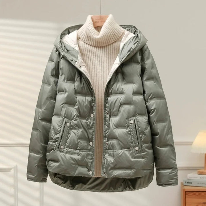 Elegant women's winter puffer jacket, a stylish outerwear choice with a quilted finish and practical snap front closure.
