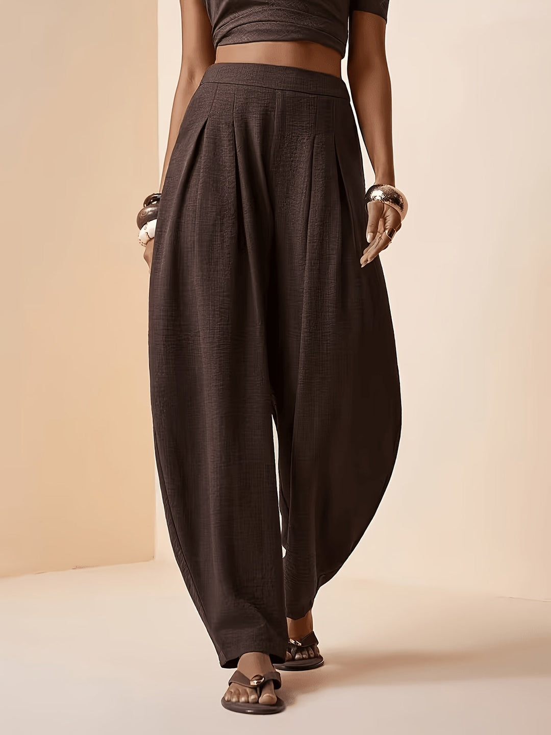 Women's high waist coffee brown harem pants with pleats and tapered ankle for a relaxed, comfortable fit.