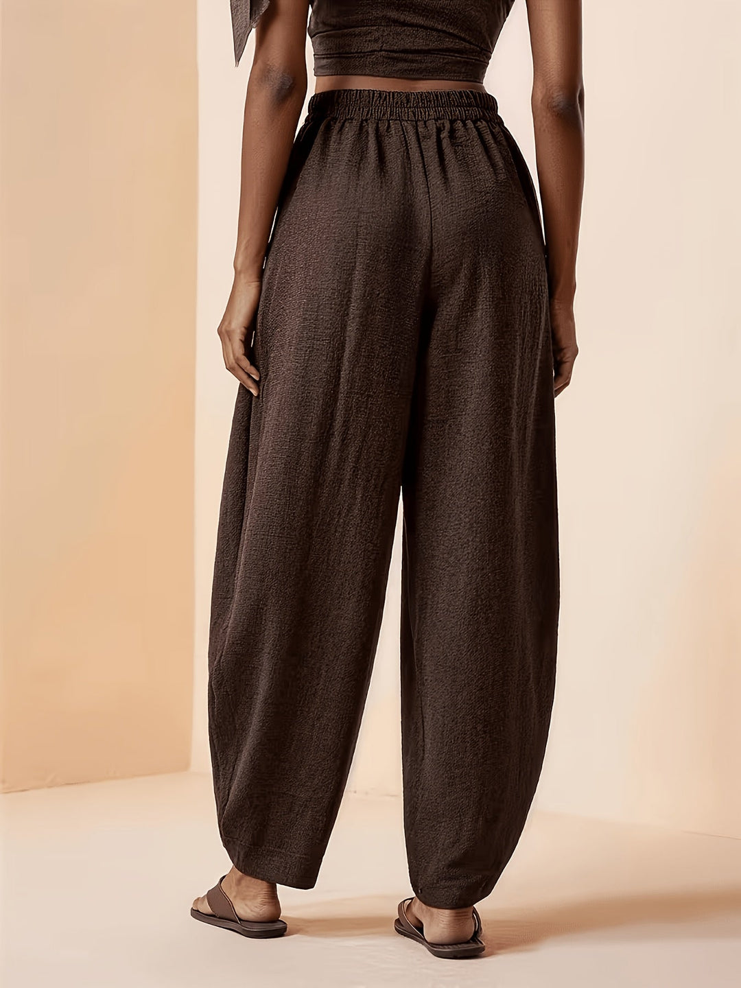 Stylish women's coffee brown pleated high waist harem pants, perfect for casual wear or travel comfort.