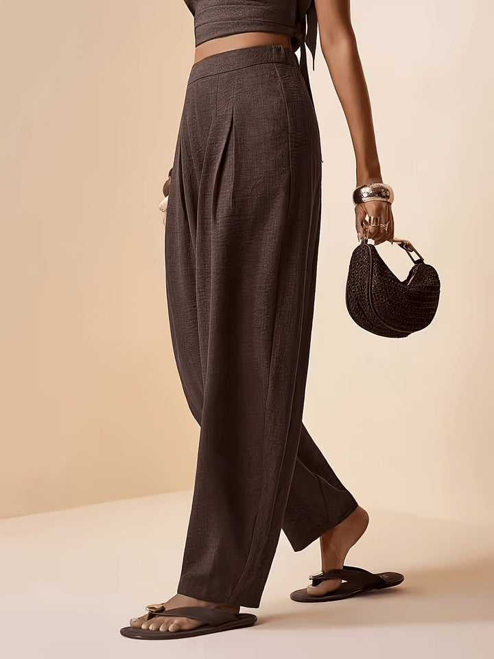 Relaxed fit coffee brown high waist harem pants for women, featuring elegant pleats and tapered ankles.