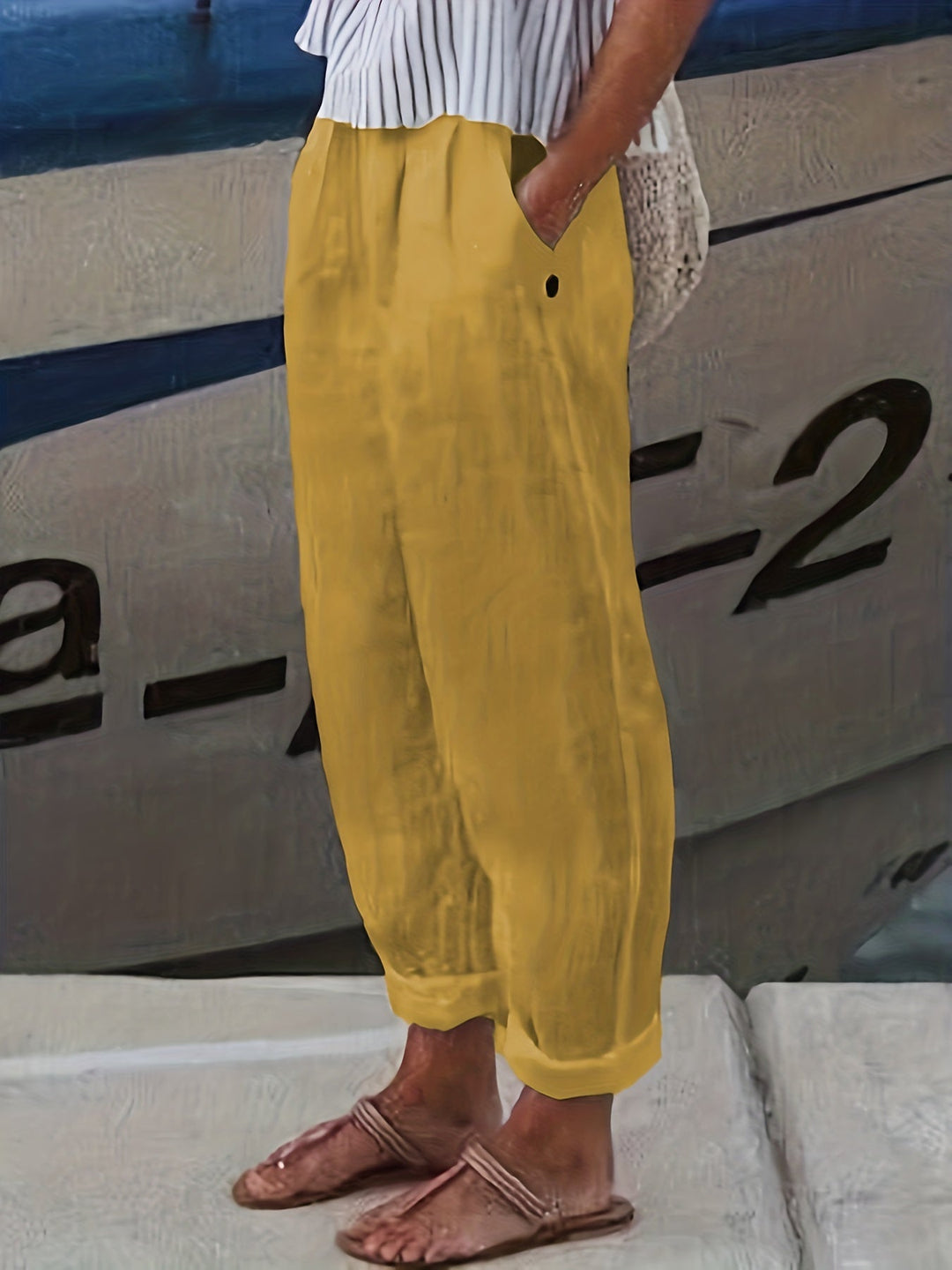 Chic women's high waist relaxed pants, featuring a roll hem, pockets, and a comfortable elastic waist for summer.