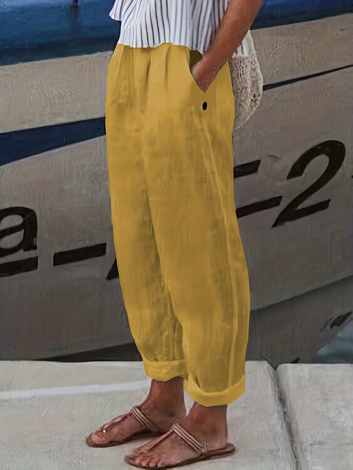 Chic women's high waist relaxed pants, featuring a roll hem, pockets, and a comfortable elastic waist for summer.