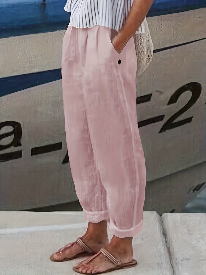 Women's relaxed fit high waist summer pants with roll hem, ideal for holidays, beach days, and comfortable wear.
