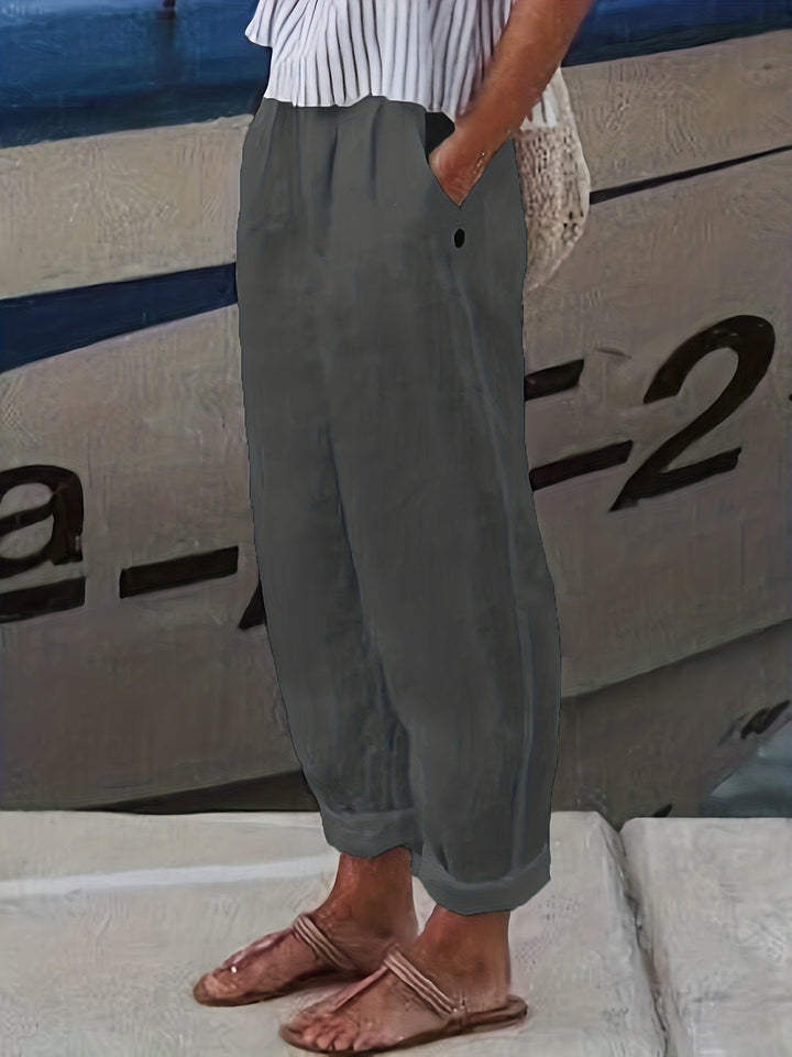 Stylish women's high waist pants, relaxed through the leg with a unique roll hem detail and pockets.