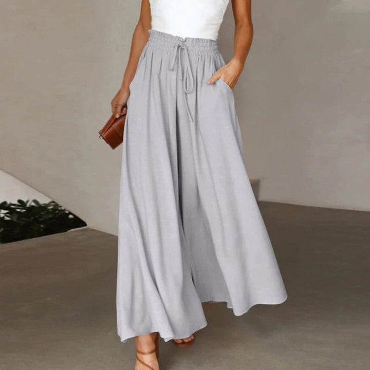 Relaxed fit women's high waist wide leg pants with soft fabric, drawstring, and deep pockets. All-day comfort.