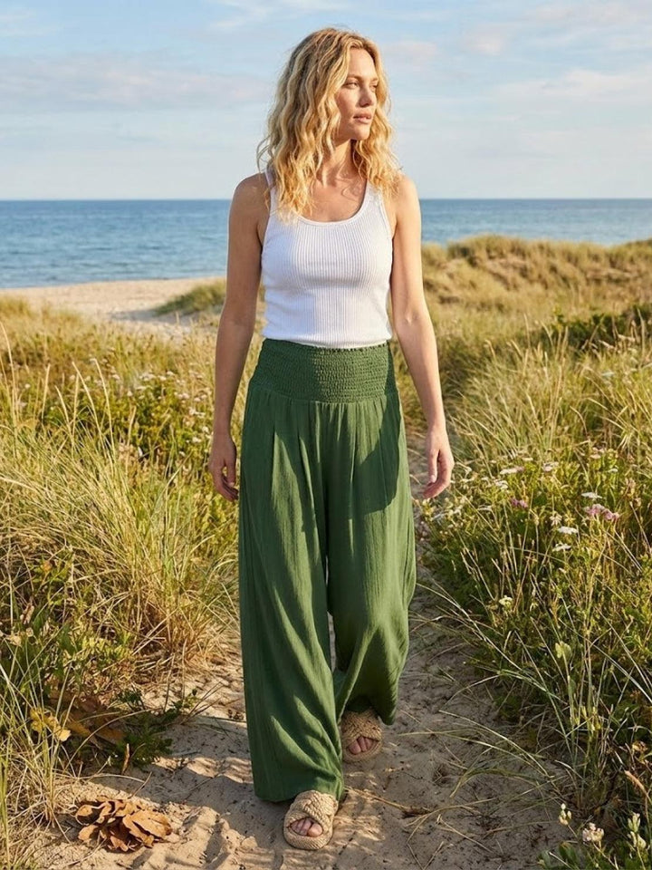 Women's smocked waist wide leg pants, high-waisted for a comfortable, relaxed, & stylish look.