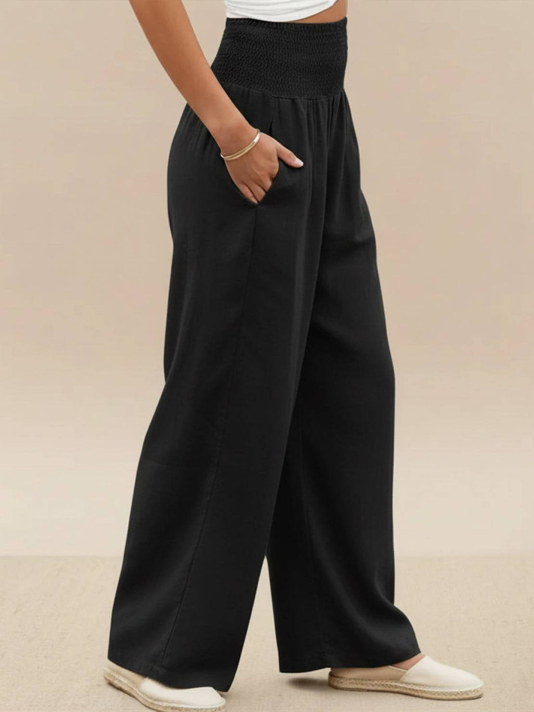 Women's pull-on high waist wide leg trousers, smocked for a comfortable and flowy fit.