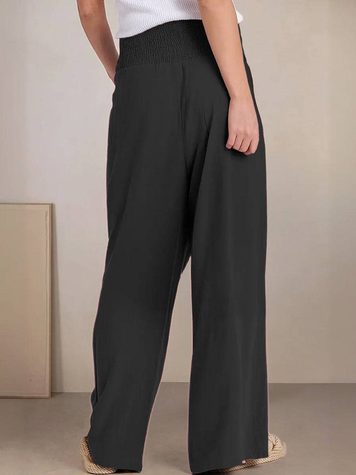 Comfortable women's smocked high waist wide leg pants, perfect for spring & summer style.