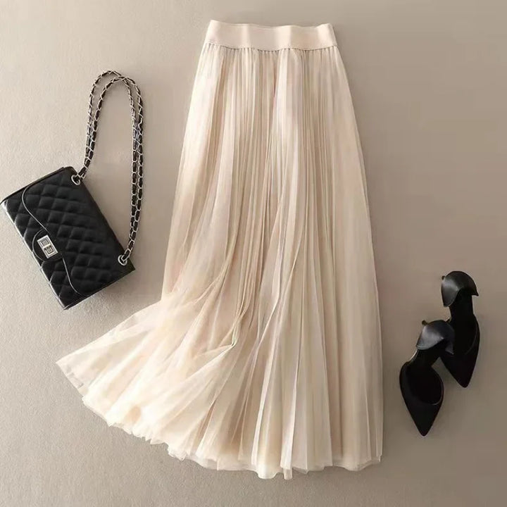 Fashionable women's A-line midi skirt, high-waisted with sophisticated pleats for modern style.