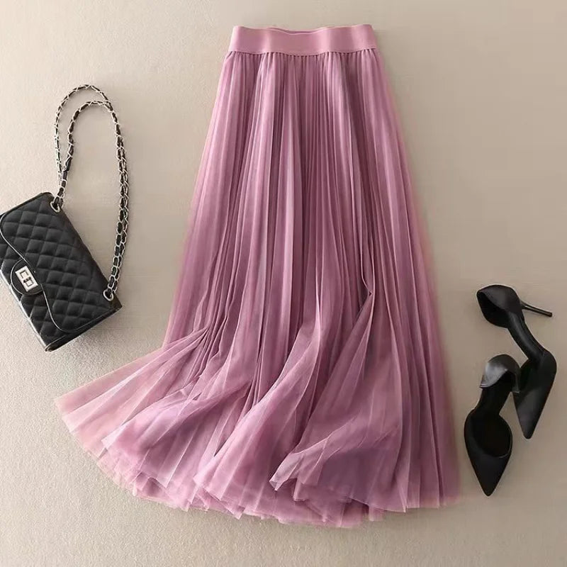 Woman wearing a versatile high-waisted pleated midi skirt, styled for a chic everyday look.
