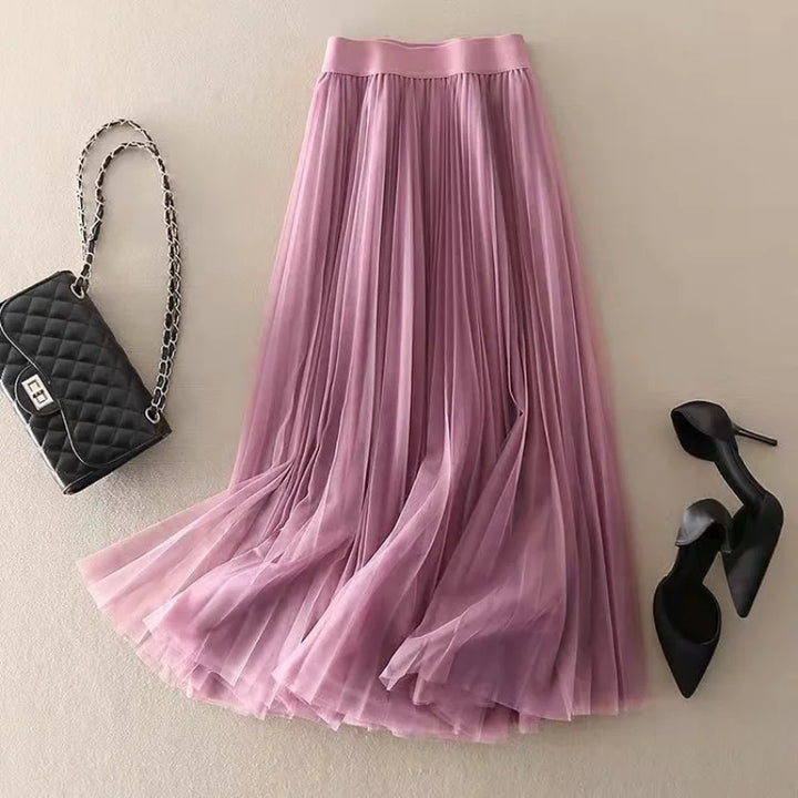 Woman wearing a versatile high-waisted pleated midi skirt, styled for a chic everyday look.
