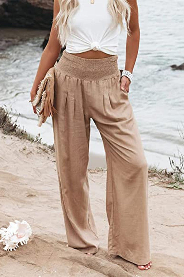 Women's high-waisted smocked linen wide leg pants, perfect for summer resort wear.