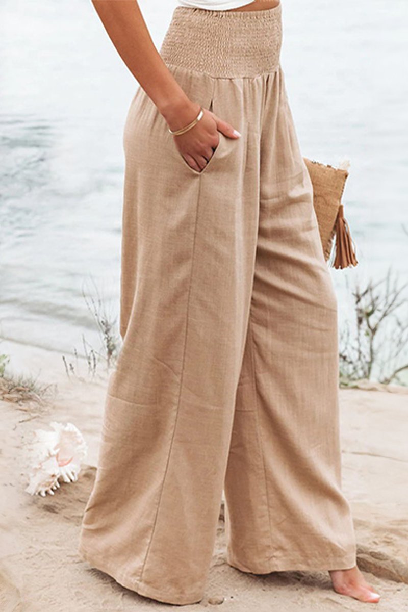 Flowing wide leg palazzo pants for women with a comfortable smocked elastic waist.