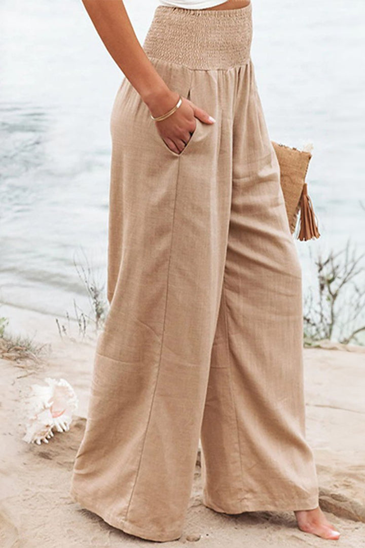 Flowing wide leg palazzo pants for women with a comfortable smocked elastic waist.